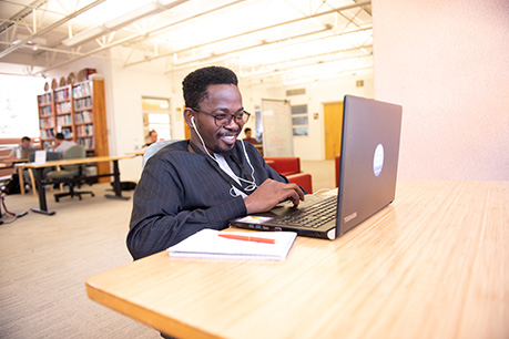 A student on their laptop. Links to Beneficiary Designations designations.jpg