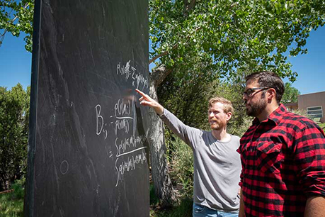 Man pointing at a blackboard. Link to Tangible Personal Property property.jpg