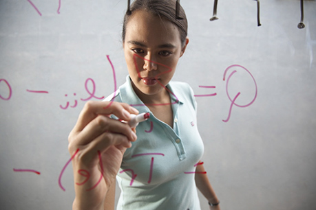 Woman writing on whiteboard. Link to Life Stage Gift Planner Under Age 60 Situations. lsgp_60.jpg